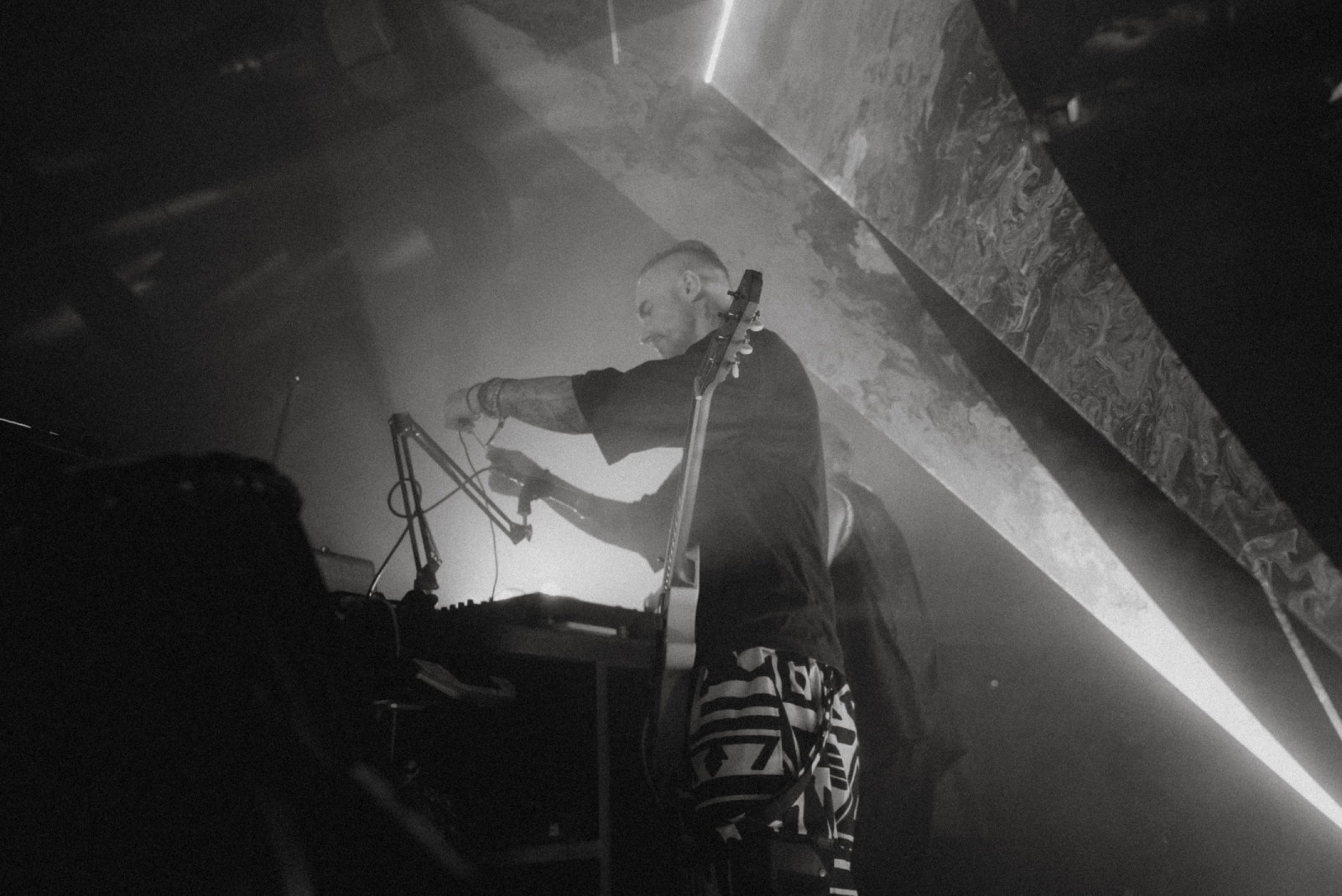 Black and white editorial shot of Nova Wolf with bass and keyboard at Bali Spirit Festival 2026